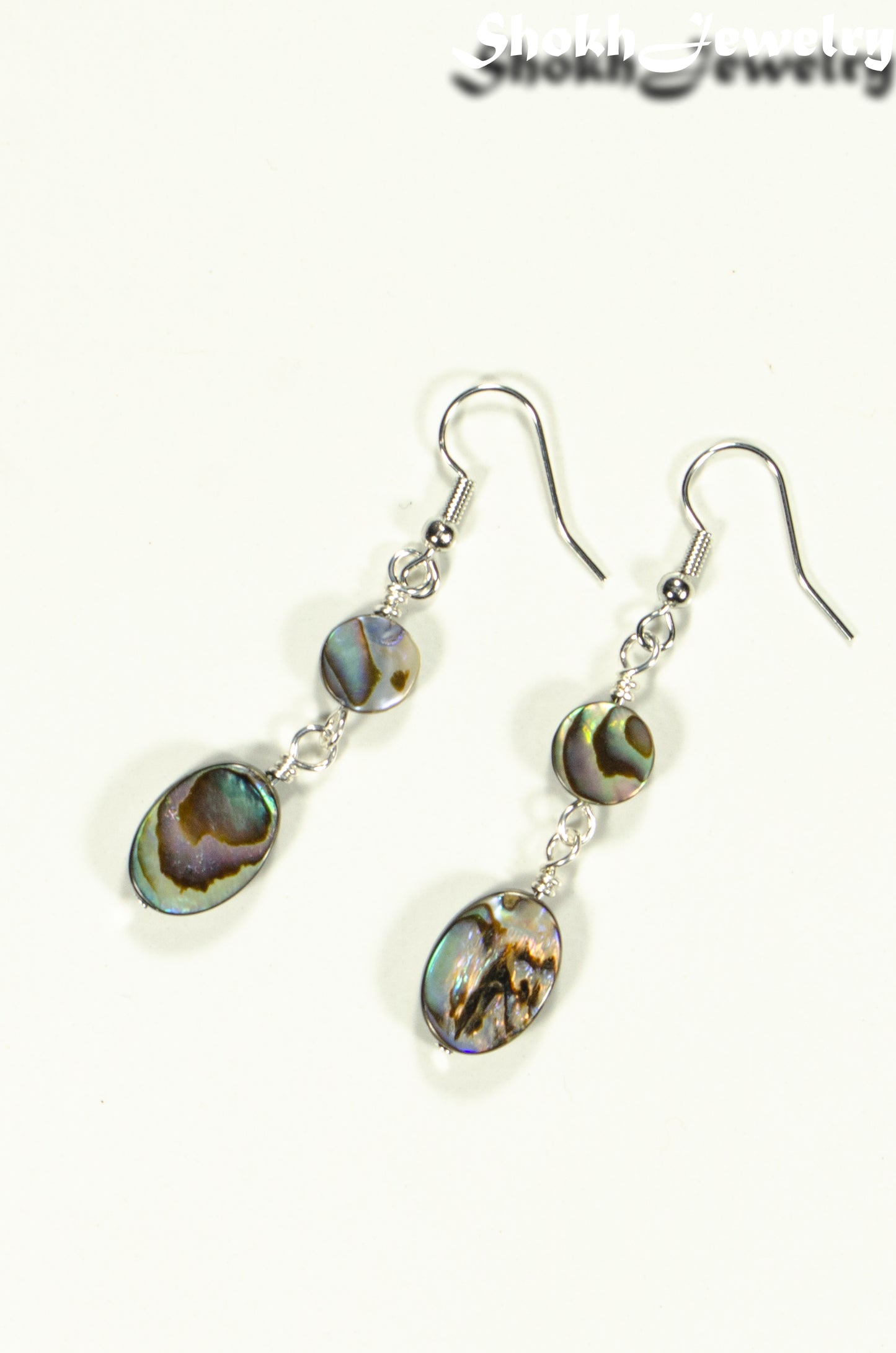 Top view of Elegant Long Oval Abalone Shell Earrings.