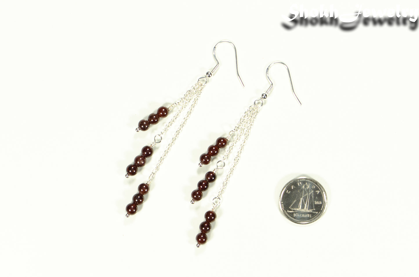 Silver Plated Chain and Garnet Crystal Earrings beside a dime.