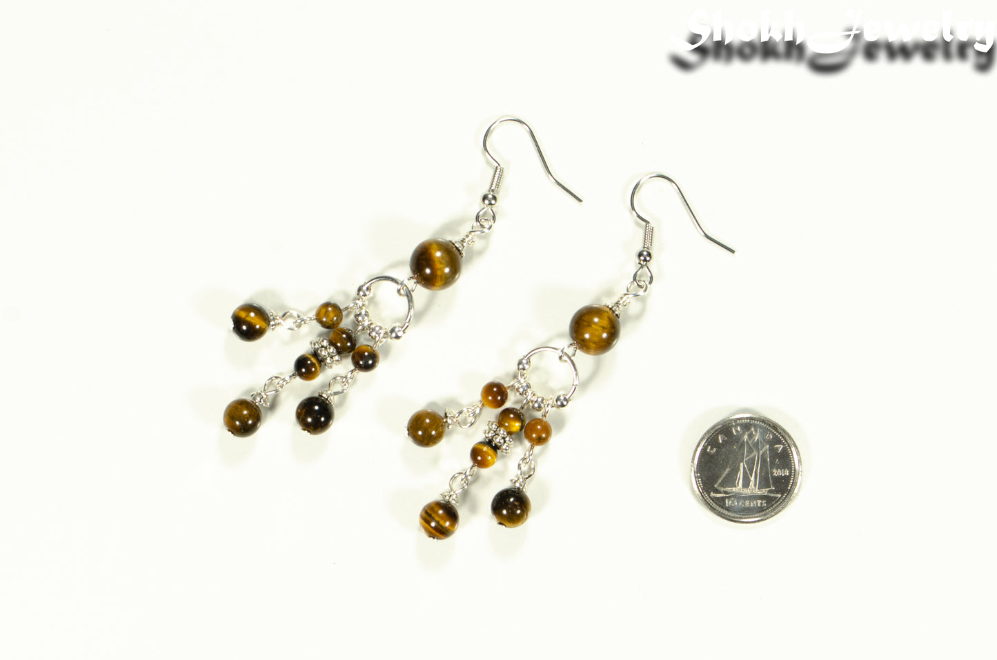 Statement Tiger's Eye Chandelier Earrings beside a dime.