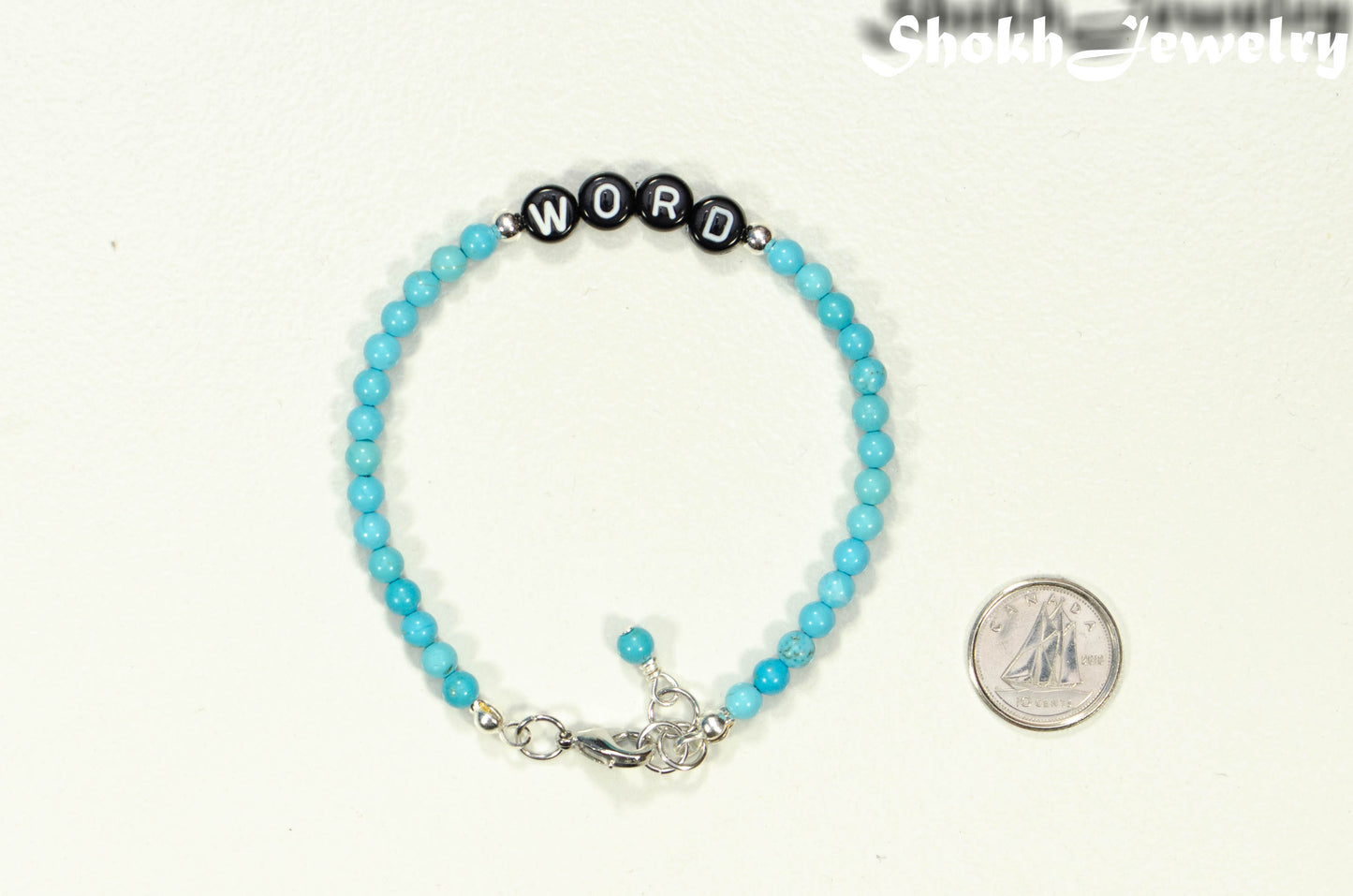 Personalized Turquoise Howlite Bracelet with Clasp beside a dime.