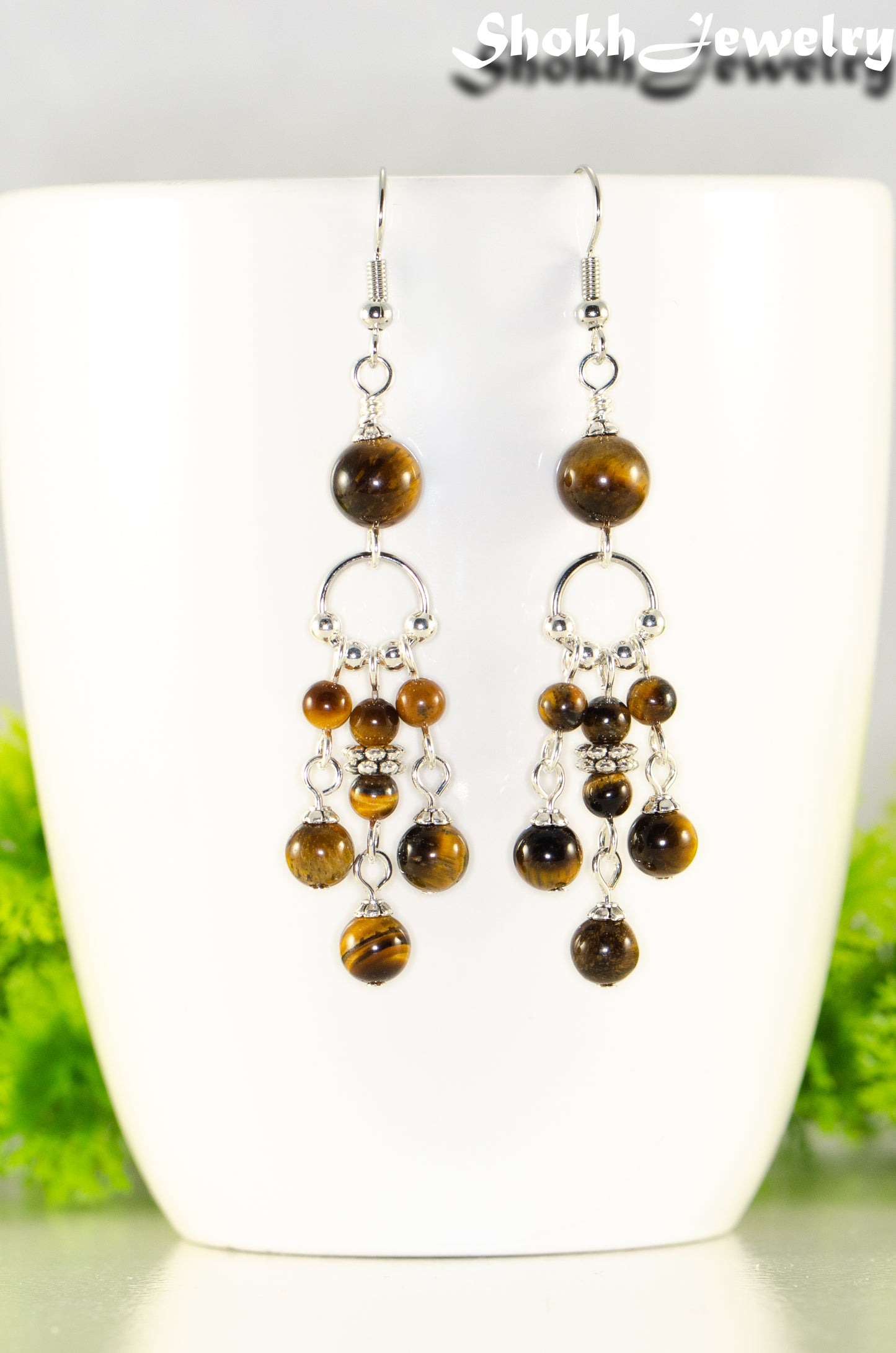 Close up of Statement Tiger's Eye Chandelier Earrings.