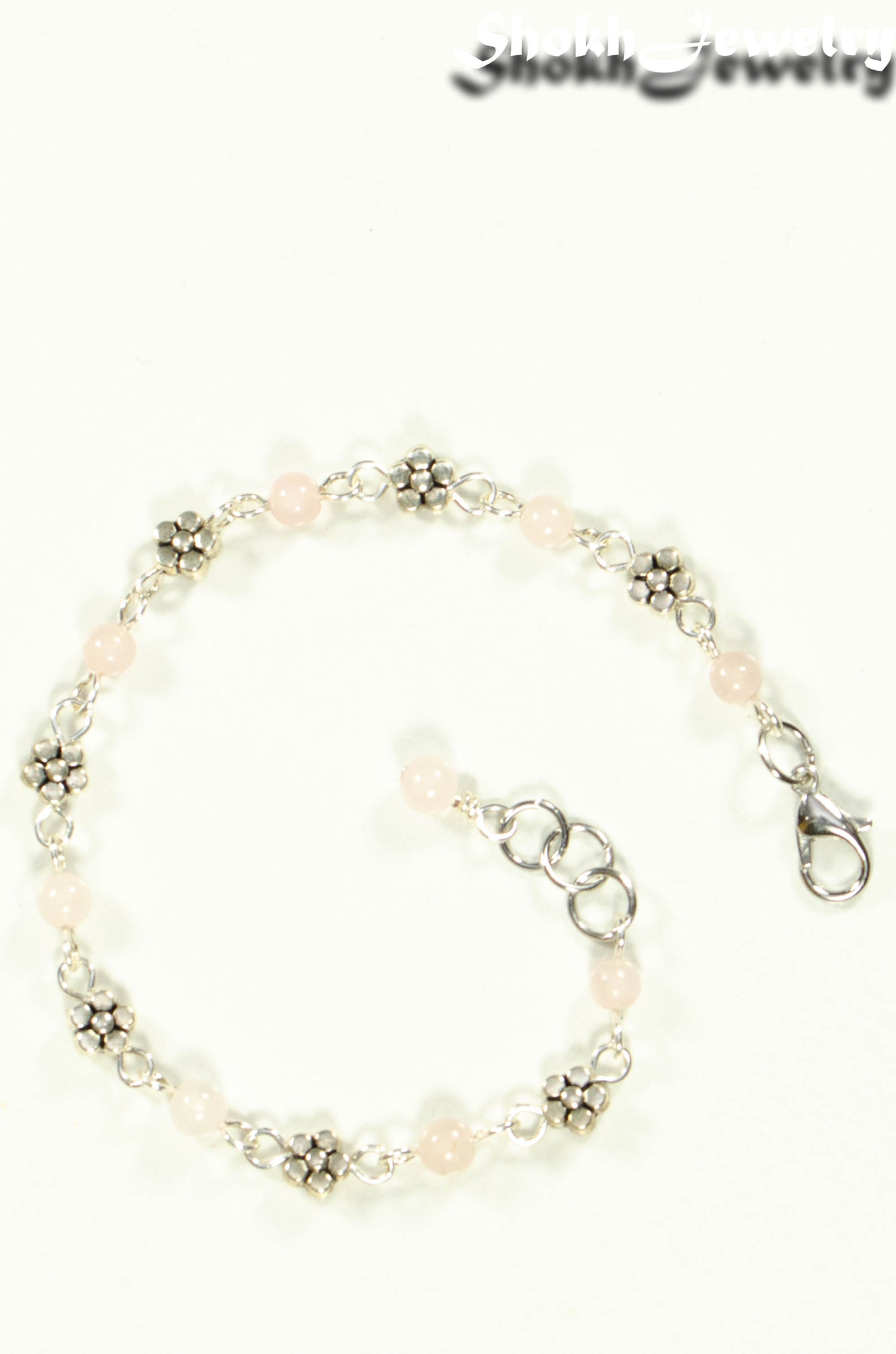 Top view of Tibetan Silver Flower and Rose Quartz Link Bracelet.