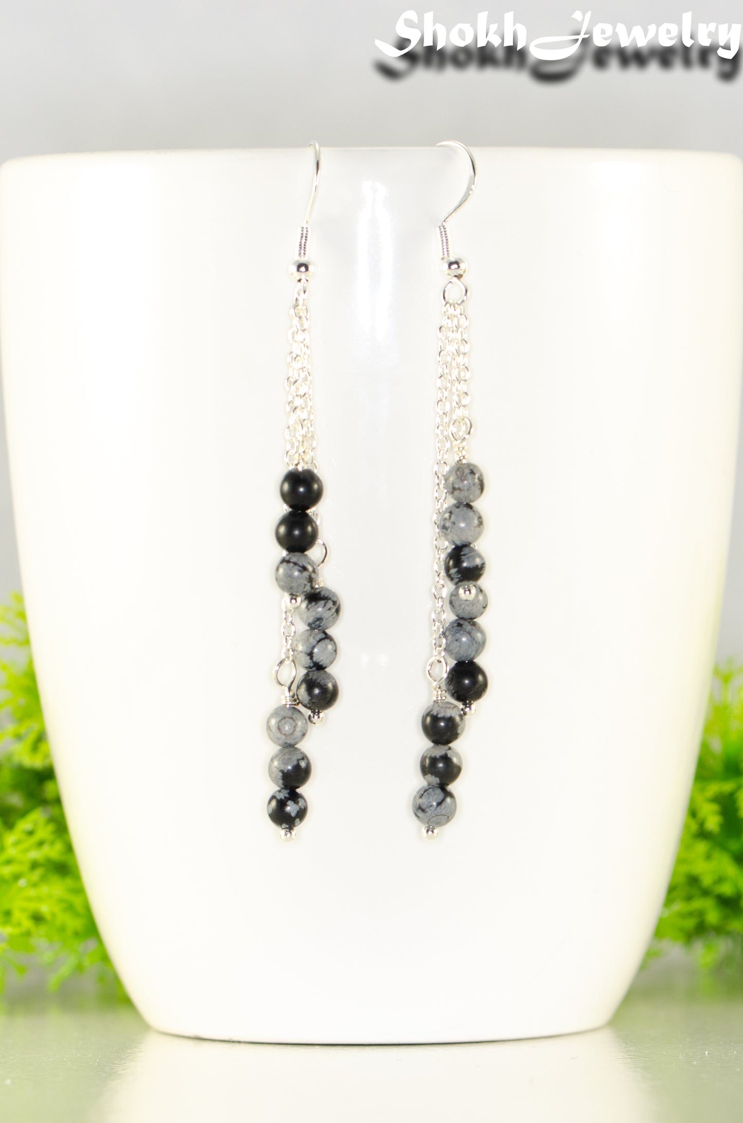 close up of Silver Plated Chain and Snowflake Obsidian Stone Earrings.