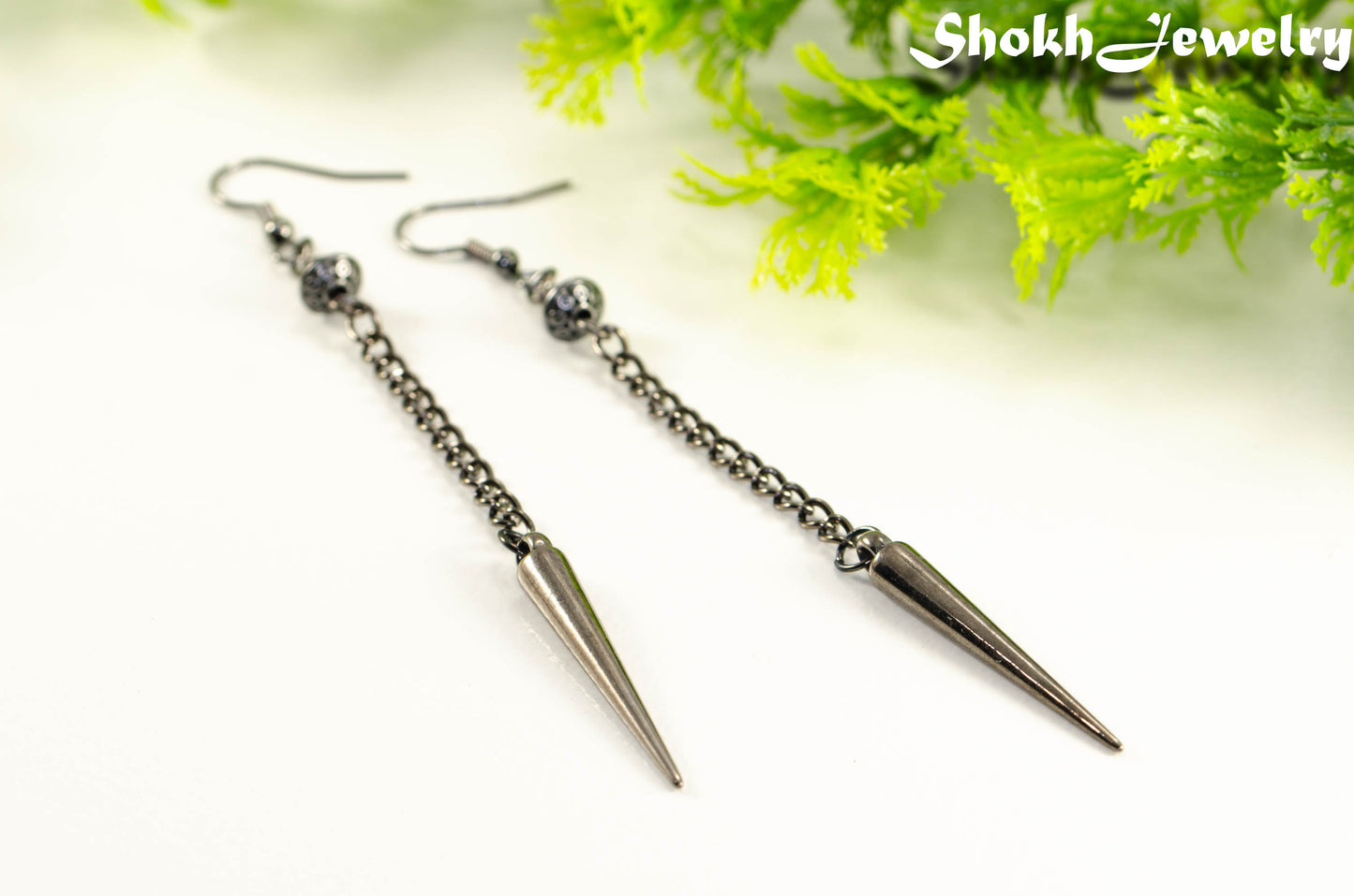 Close up of Statement chain and antique silver spike earrings