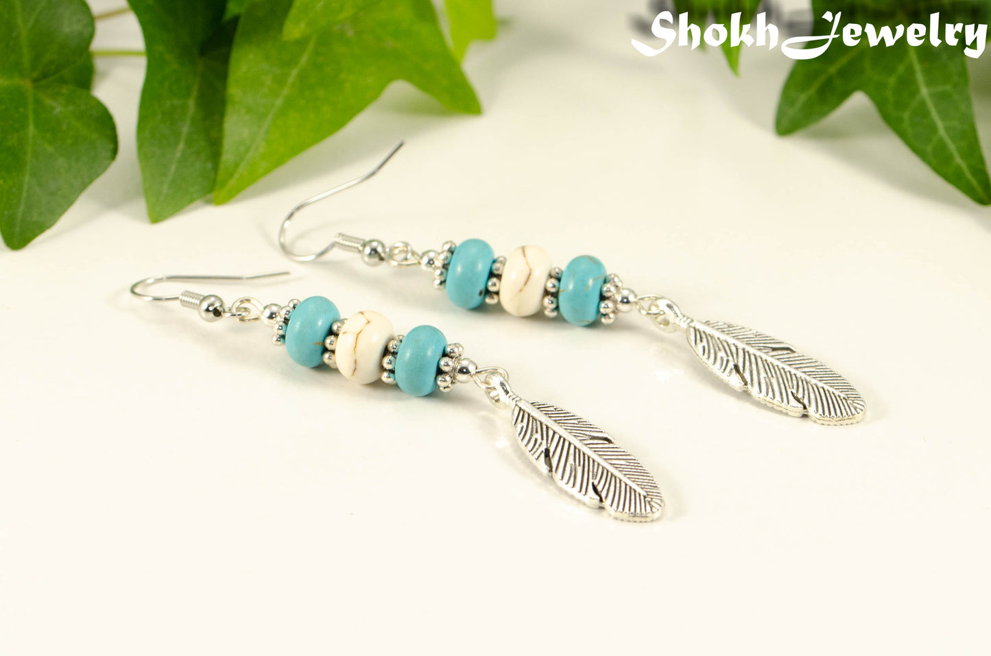 Statement Turquoise And White Howlite And Feather Earrings.
