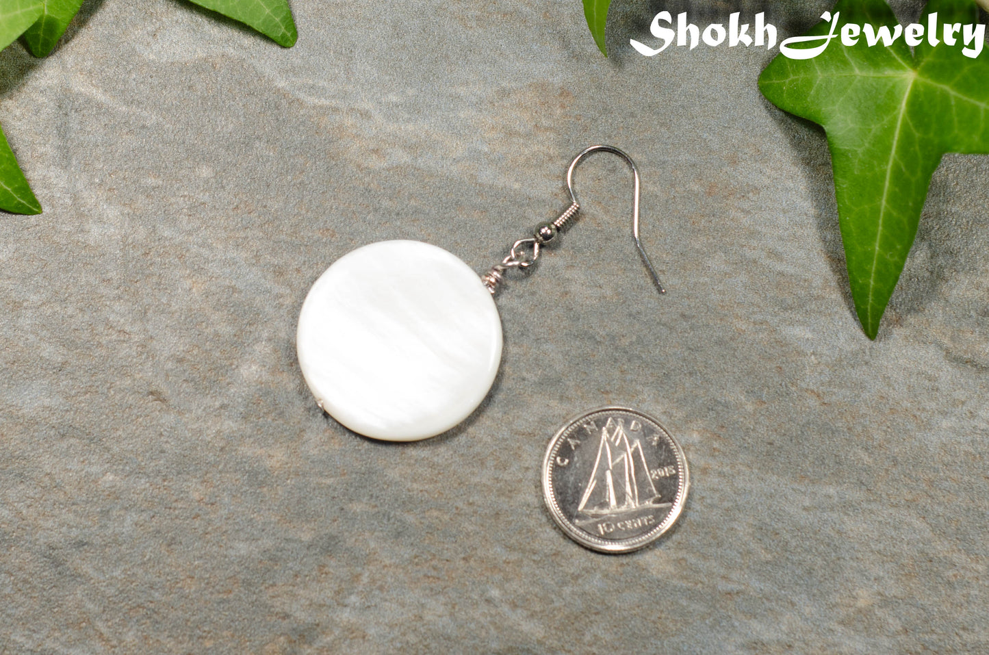 25mm White Seashell Earring beside a dime.