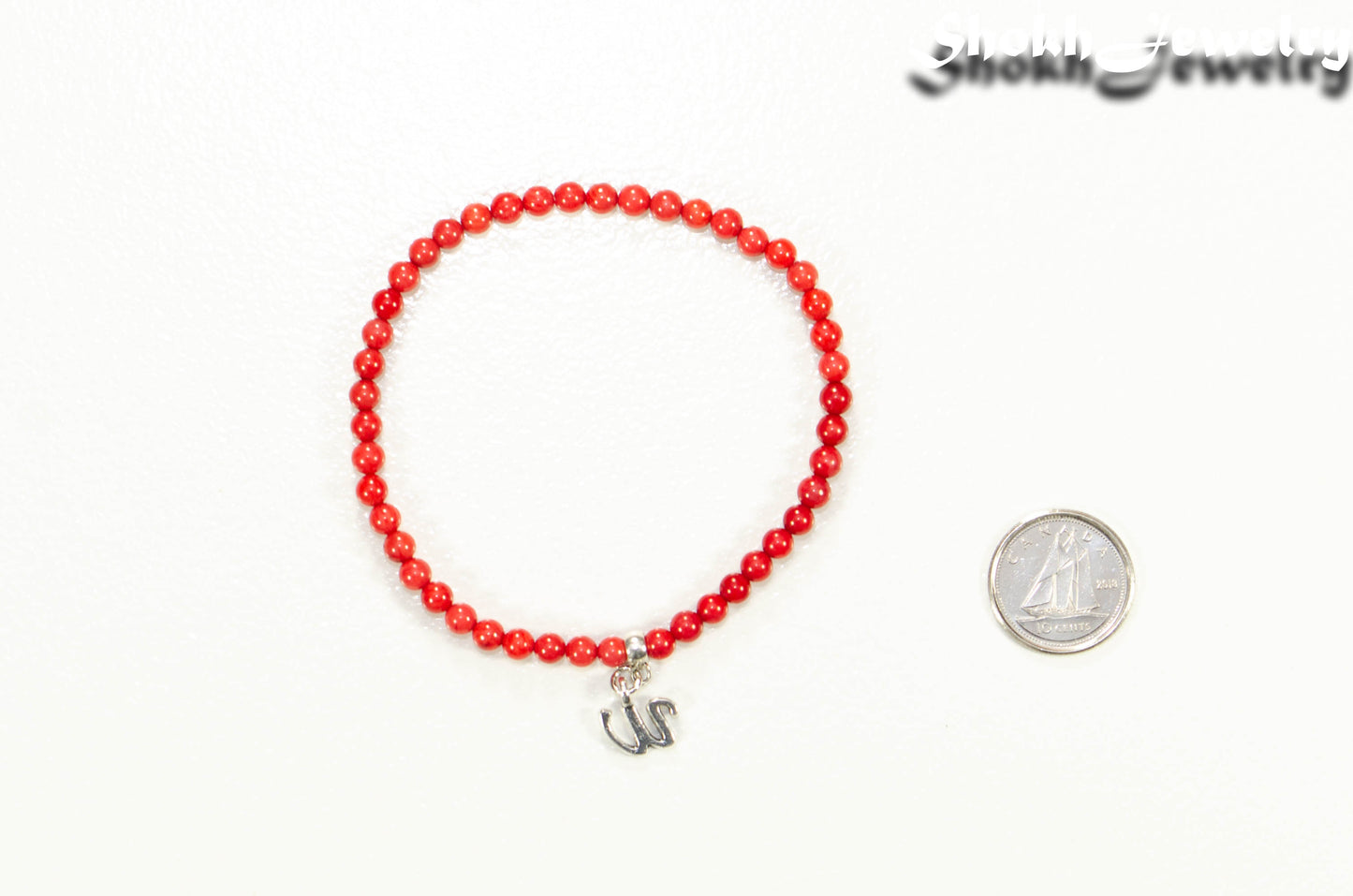 4mm Red Coral Bracelet with Initial beside a dime