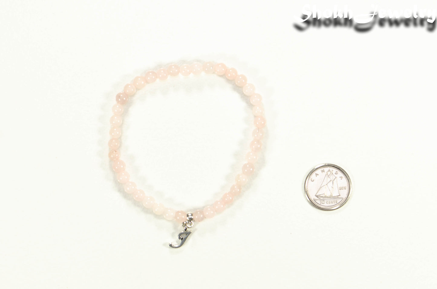 4mm Rose Quartz Bracelet with Initial beside a dime