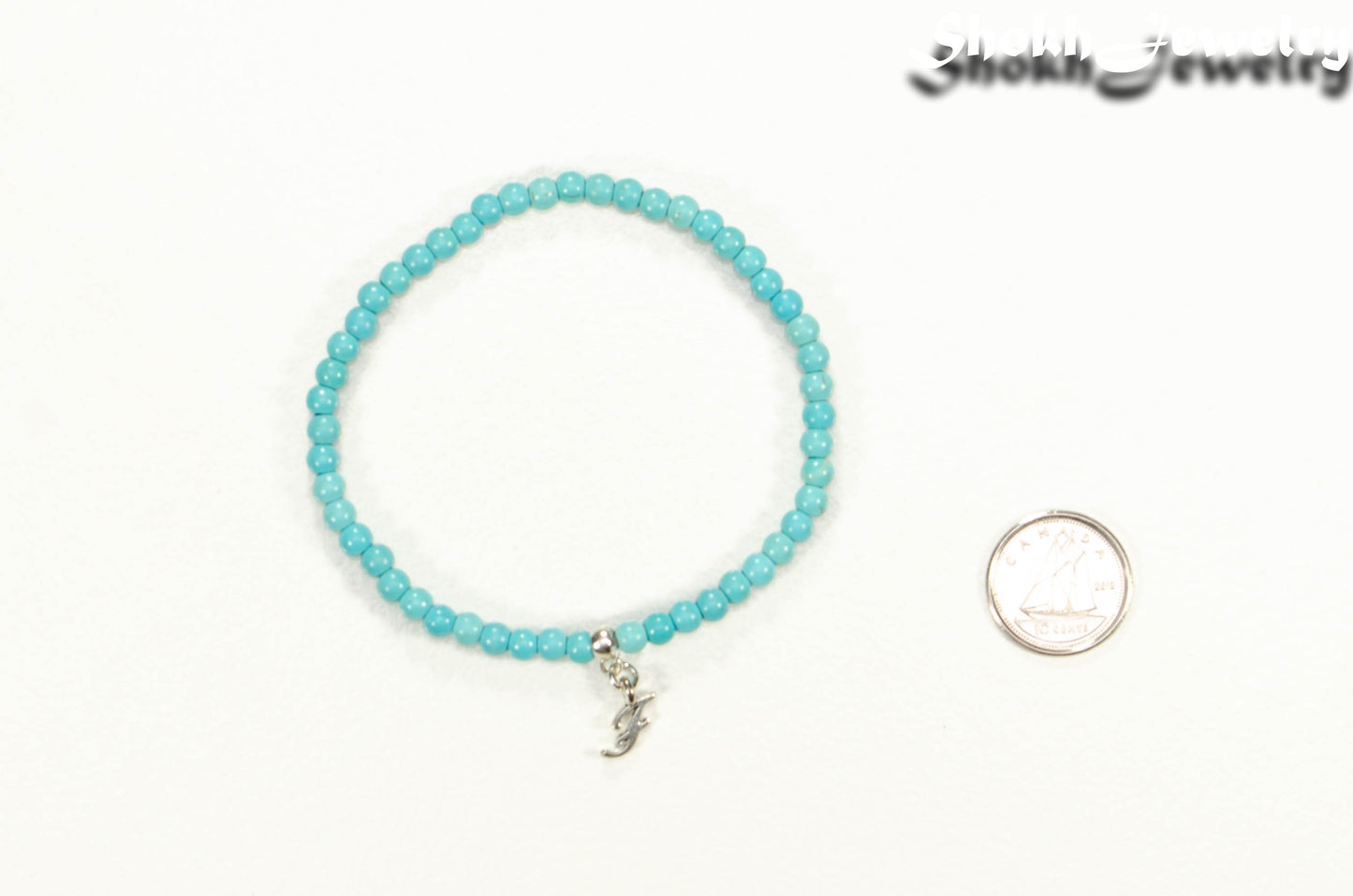 4mm Turquoise Howlite Bracelet with Initial beside a dime