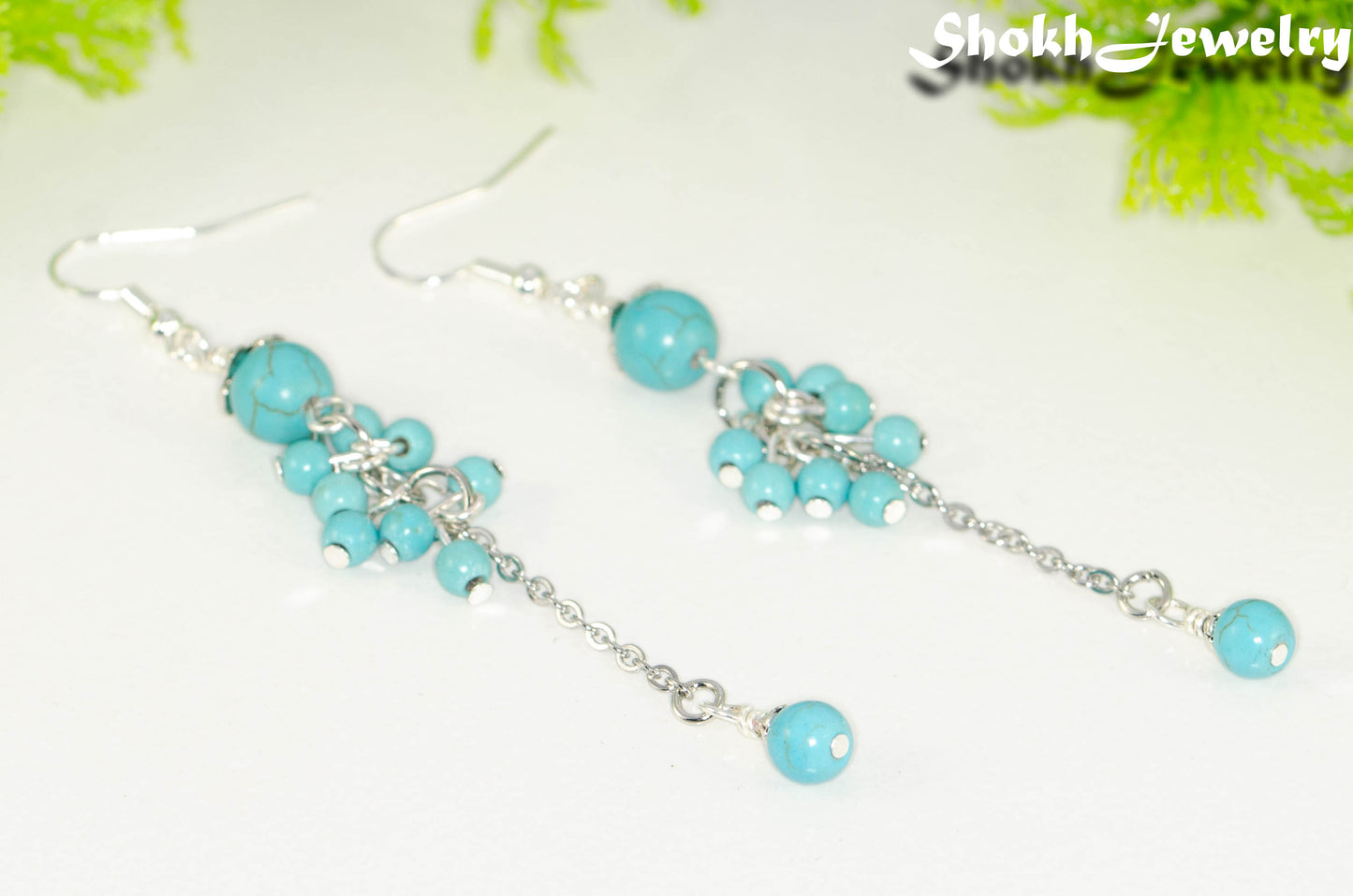 Close up of Long Stainless Steel Chain and Turquoise Howlite Earrings.