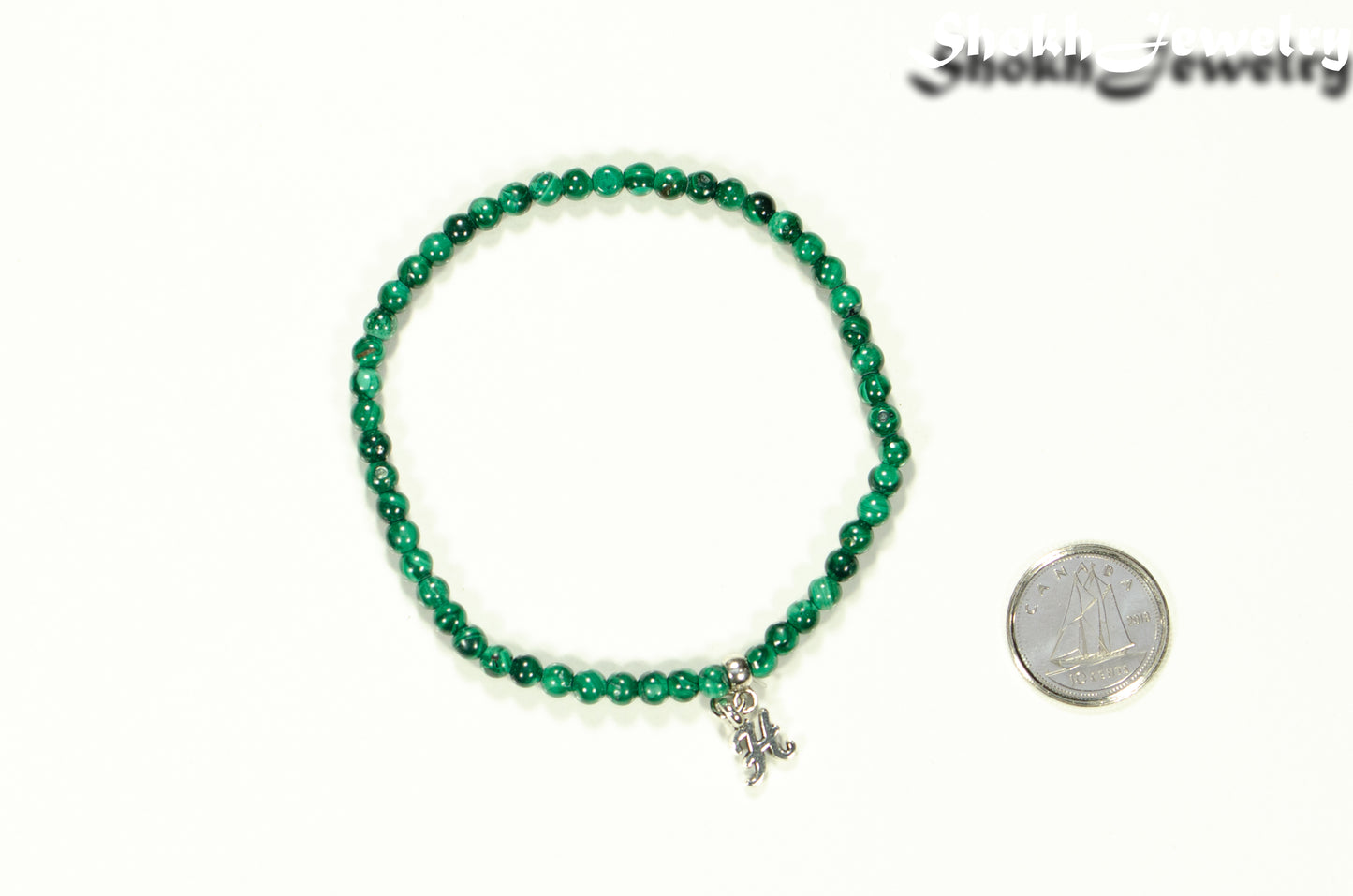 3mm Malachite Bracelet with Initial beside a dime.