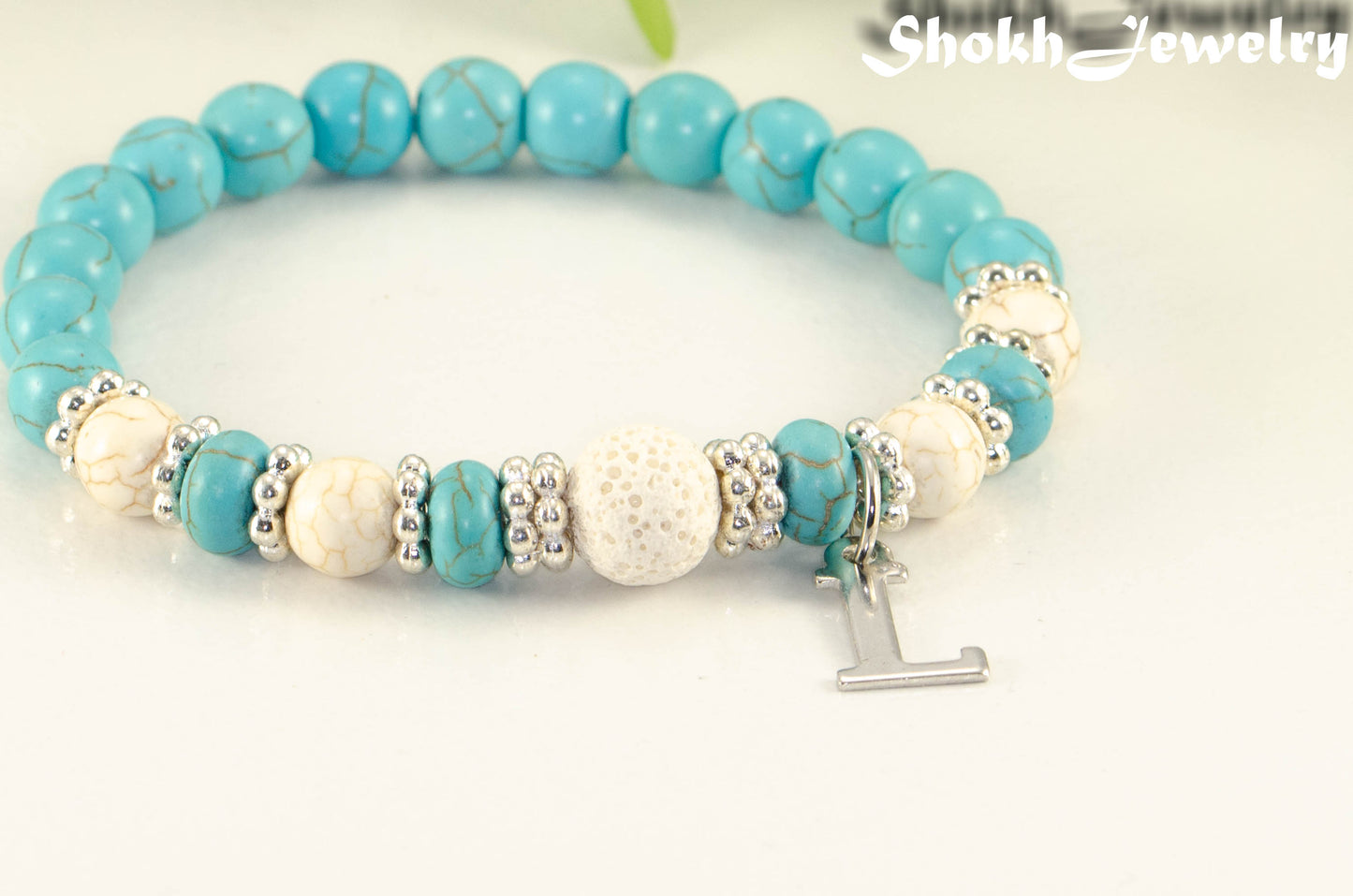 Close up of Turquoise Howlite and Lava Stone Bracelet with Initial.