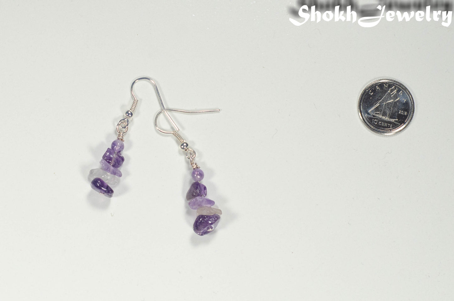 Simple Amethyst Crystal Chip Earrings beside a dime.
