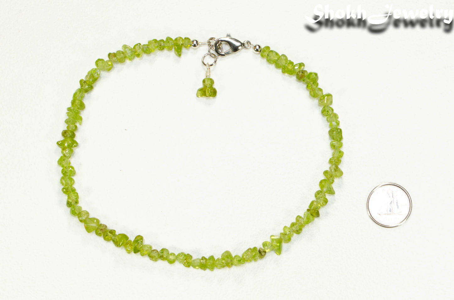 Natural Peridot Crystal Chip Anklet beside a dime