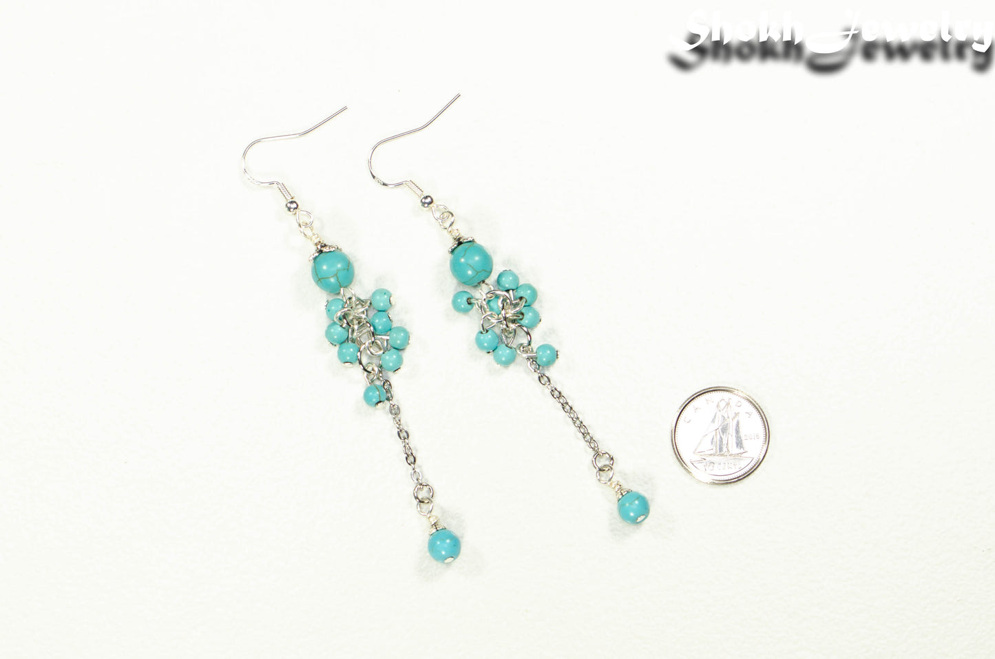 Long Stainless Steel Chain and Turquoise Howlite Earrings beside a dime.
