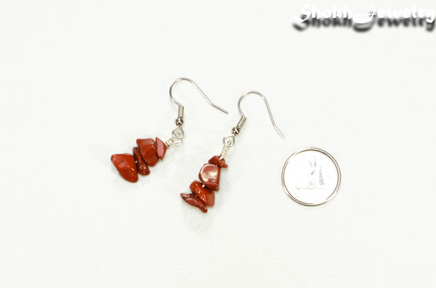 Simple Red Jasper Crystal Chip Earrings beside a dime.