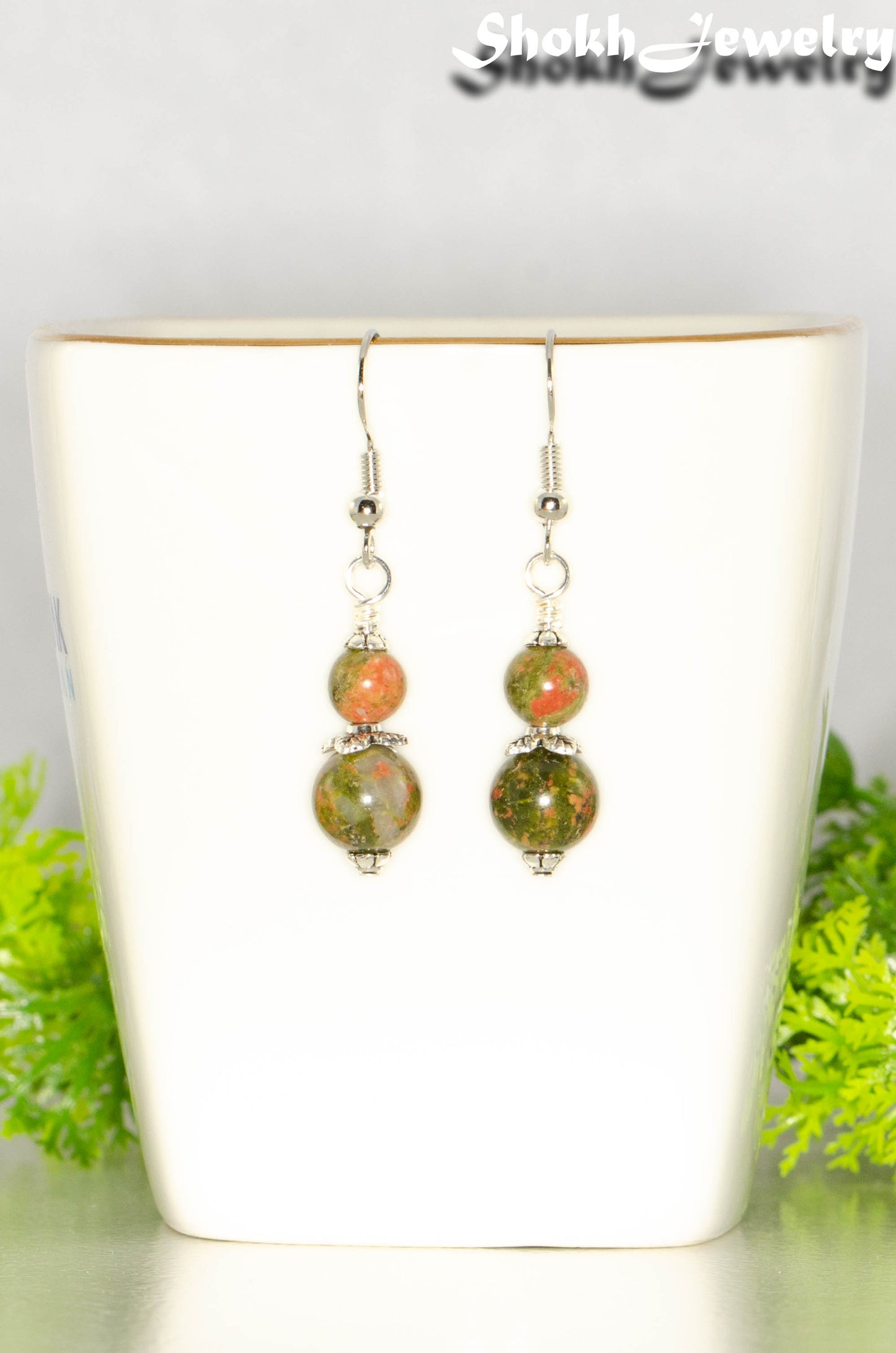 Small Unakite Jasper Earrings on a tea cup