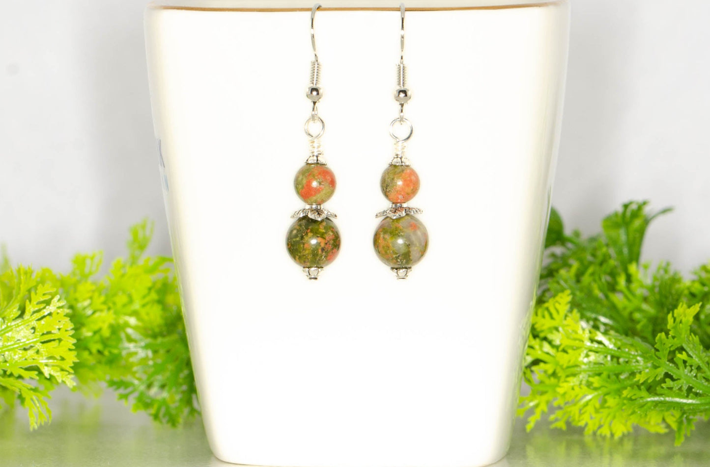 Small Unakite Jasper Earrings on a tea cup