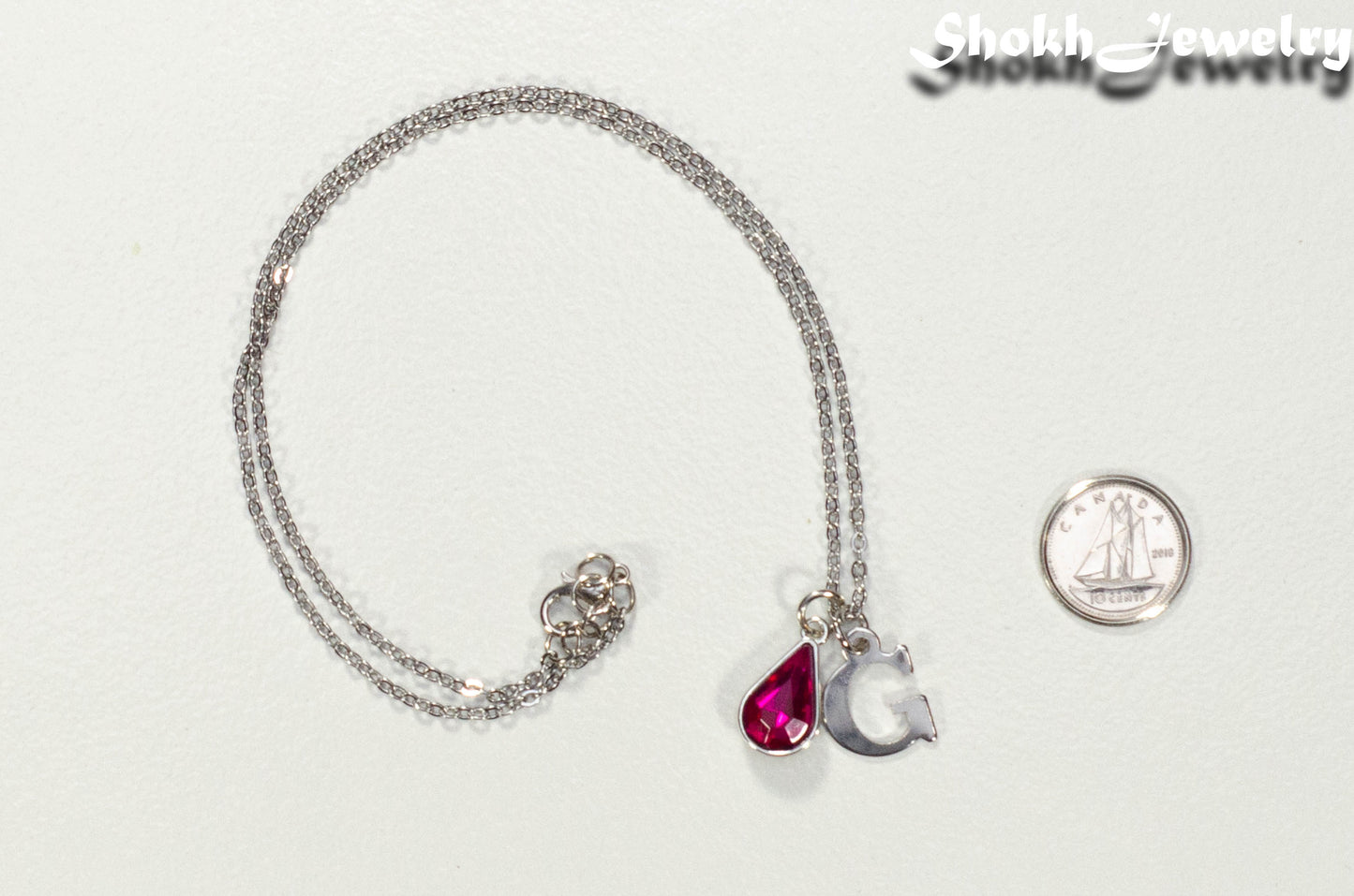 Personalized October Birthstone Choker Necklace beside a dime