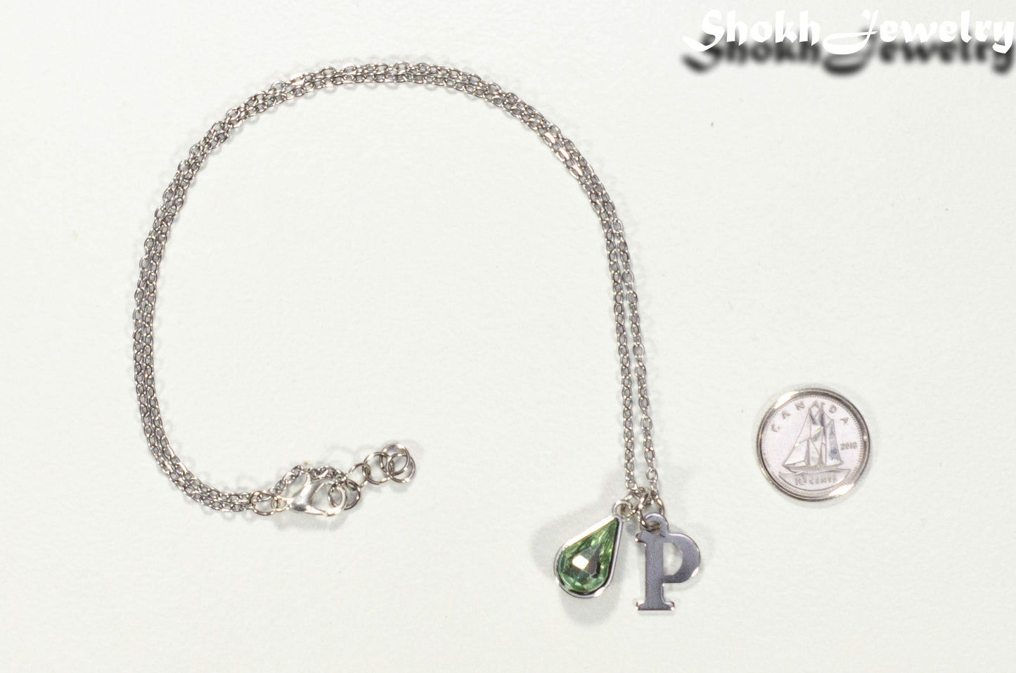Personalized August Birthstone Choker Necklace beside a dime