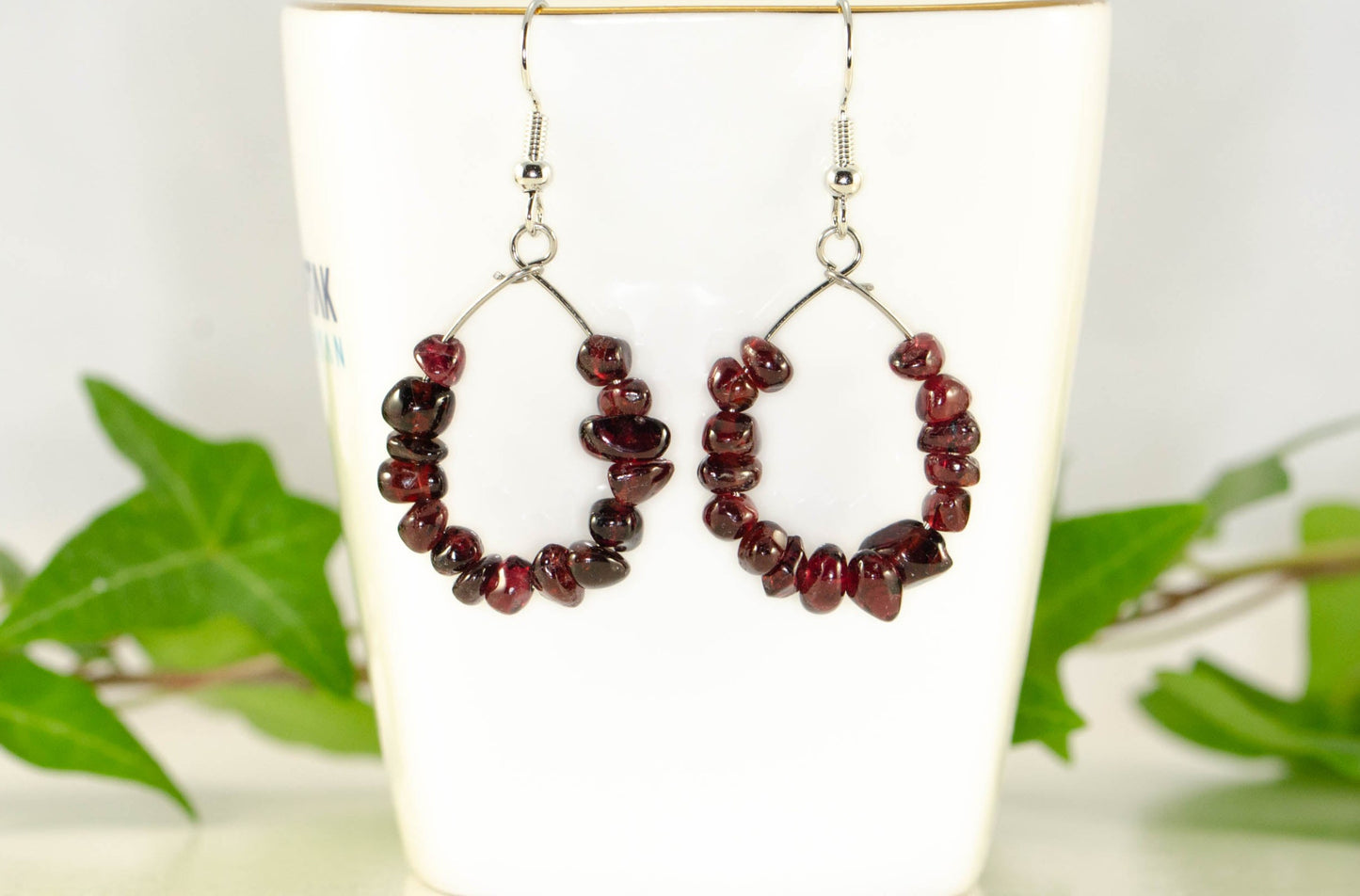 Natural Garnet Crystal Chip Earrings on a tea cup