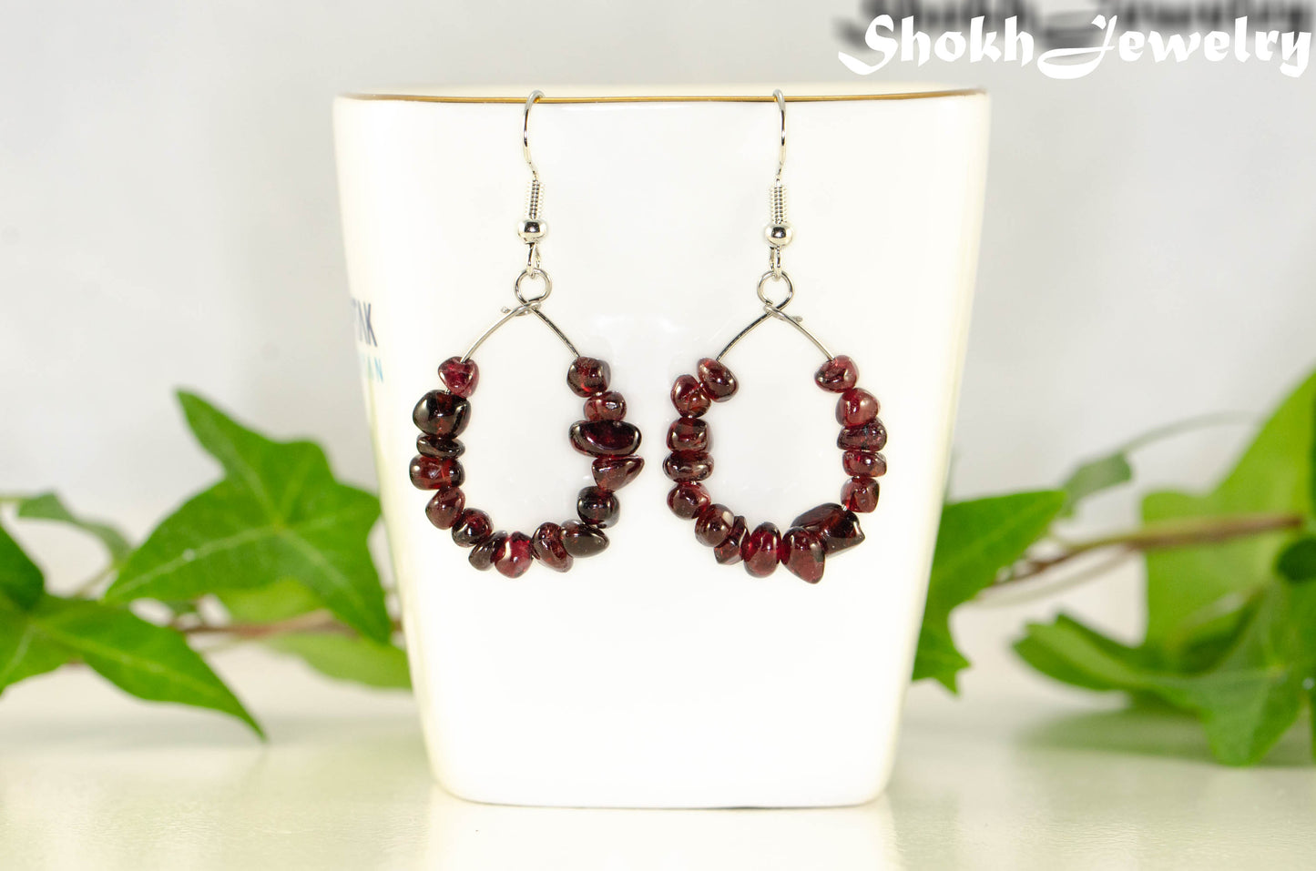 Natural Garnet Crystal Chip Earrings on a tea cup