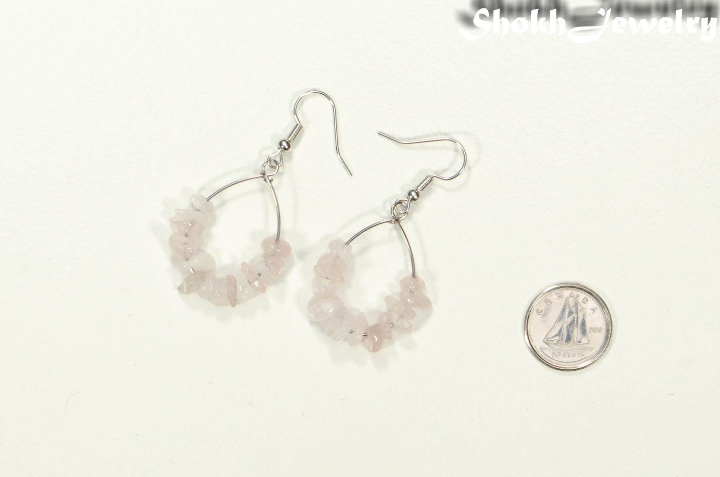 Natural Rose Quartz Crystal Chip Earrings beside a dime