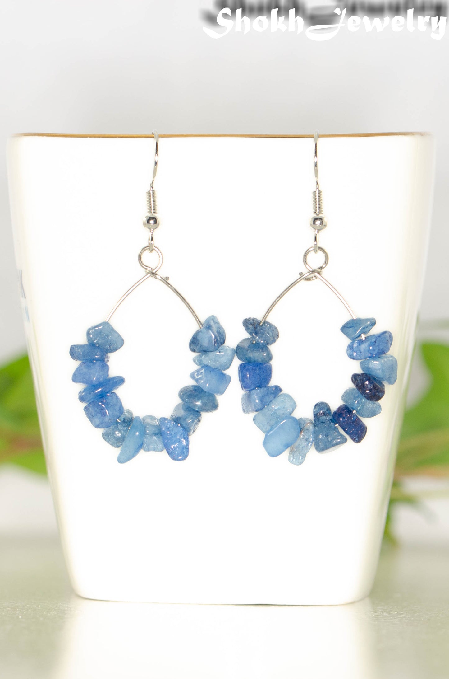 Natural Blue Quartzite Crystal Chip Earrings on a tea cup