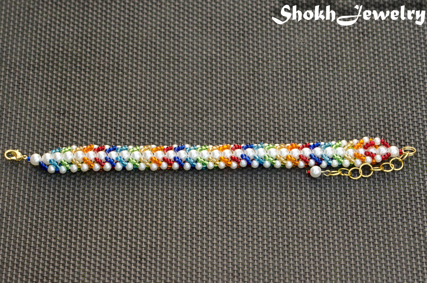 Top view of Rainbow seed bead and pearl woven bracelet.