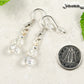 Small Crystal Clear Glass Bead Dangle Earrings beside a dime.