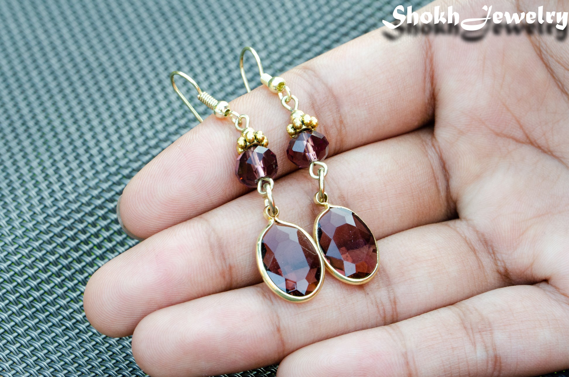 Close up of Brown Oval Glass Dangle Earrings.