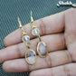 Close up of Clear Oval Glass Dangle Earrings.