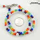 White Glass Crystal and Rainbow Seed Bead Anklet beside a dime.