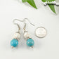 Turquoise and White Howlite Dangle Earrings beside a dime.