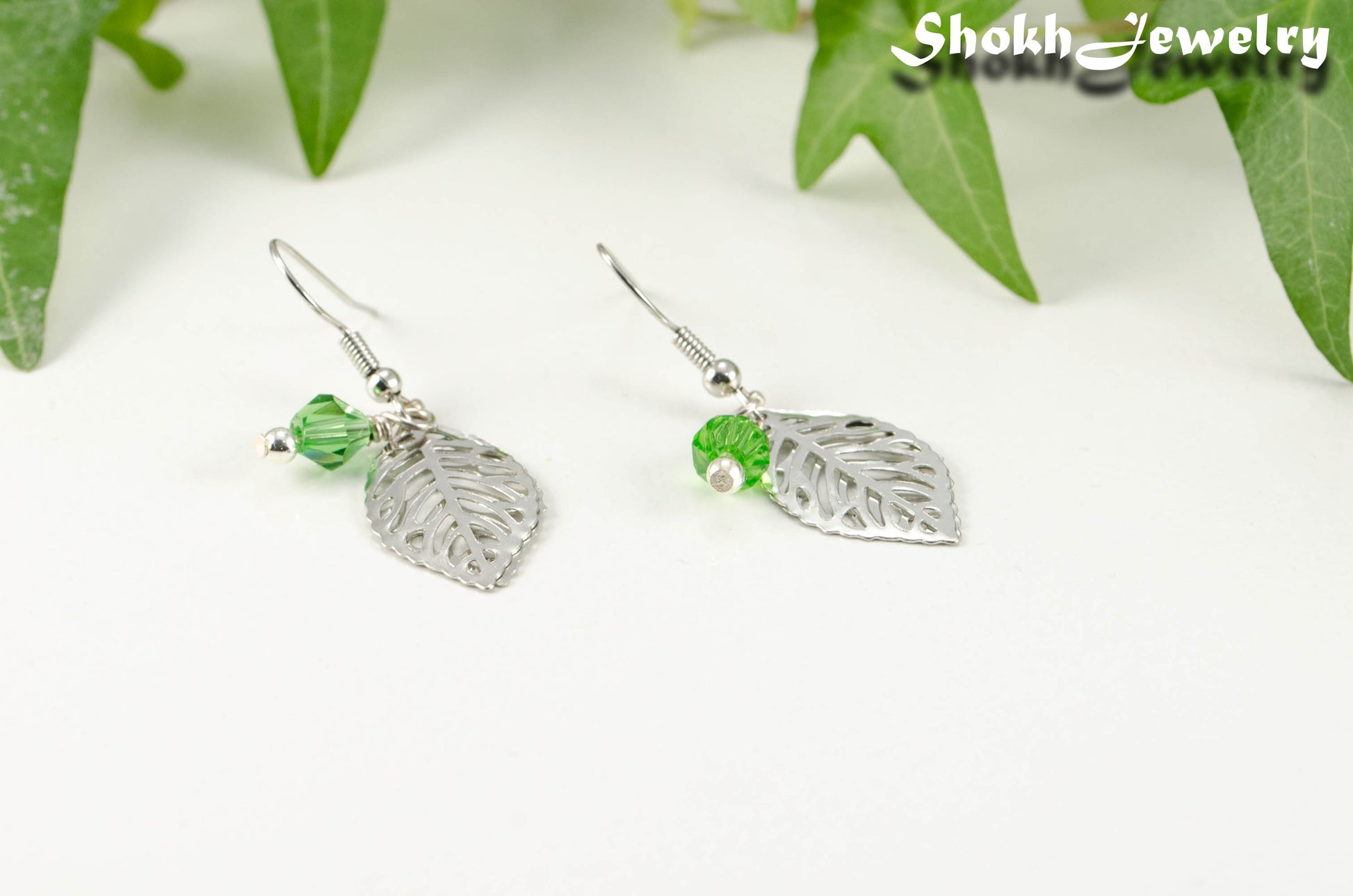 Filigree Silver Leaf Charm and Green Glass Crystal Earrings for women.