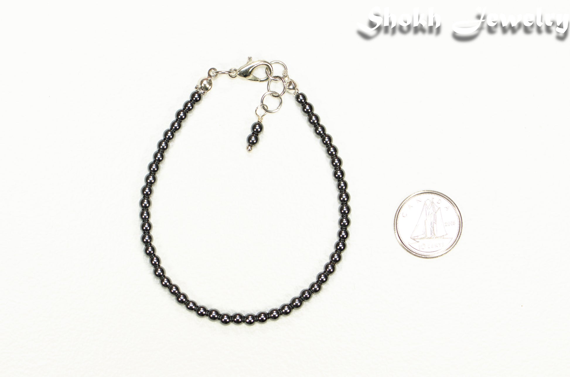 3mm Natural Hematite Anklet beside a dime.