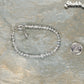 4mm Clear Quartz Anklet with Clasp beside a dime.