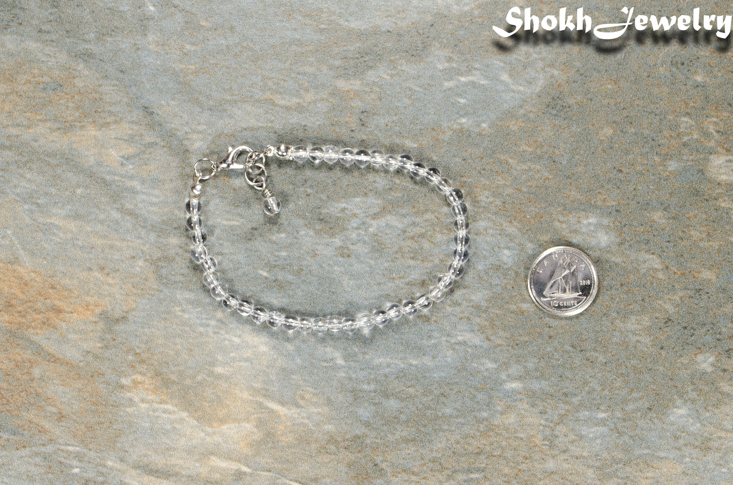 4mm Clear Quartz Anklet with Clasp beside a dime.