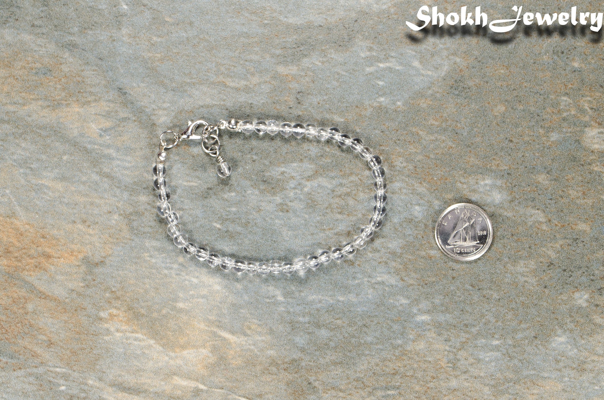 4mm Clear Quartz Anklet with Clasp beside a dime.