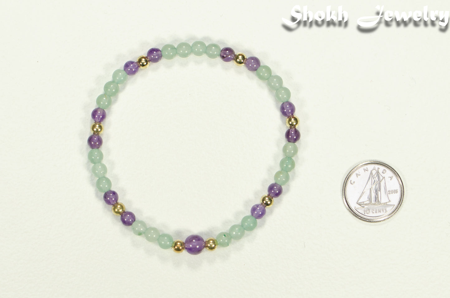 4mm Green Aventurine and Amethyst Bracelet beside a dime.