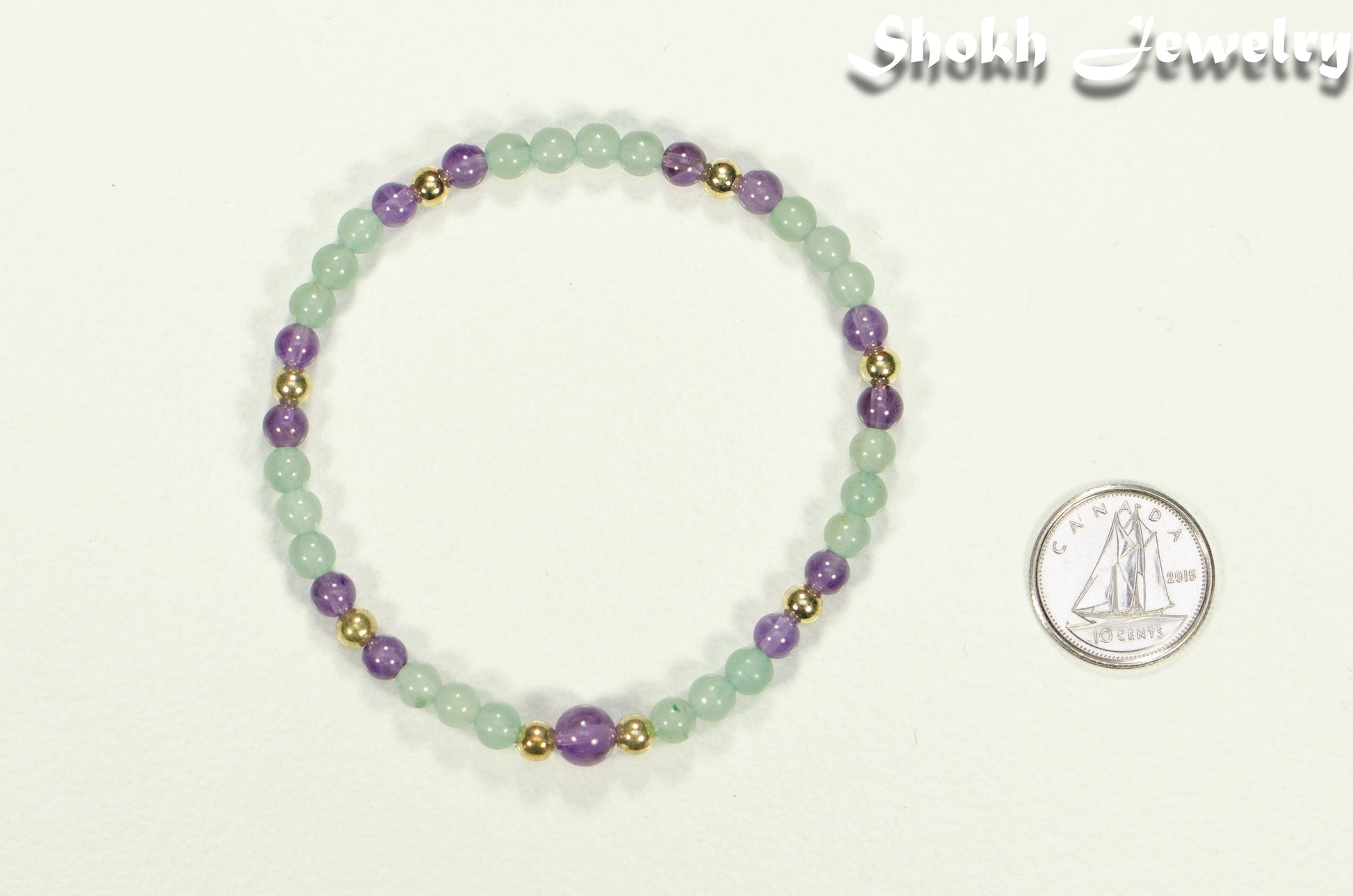 4mm Green Aventurine and Amethyst Bracelet beside a dime.