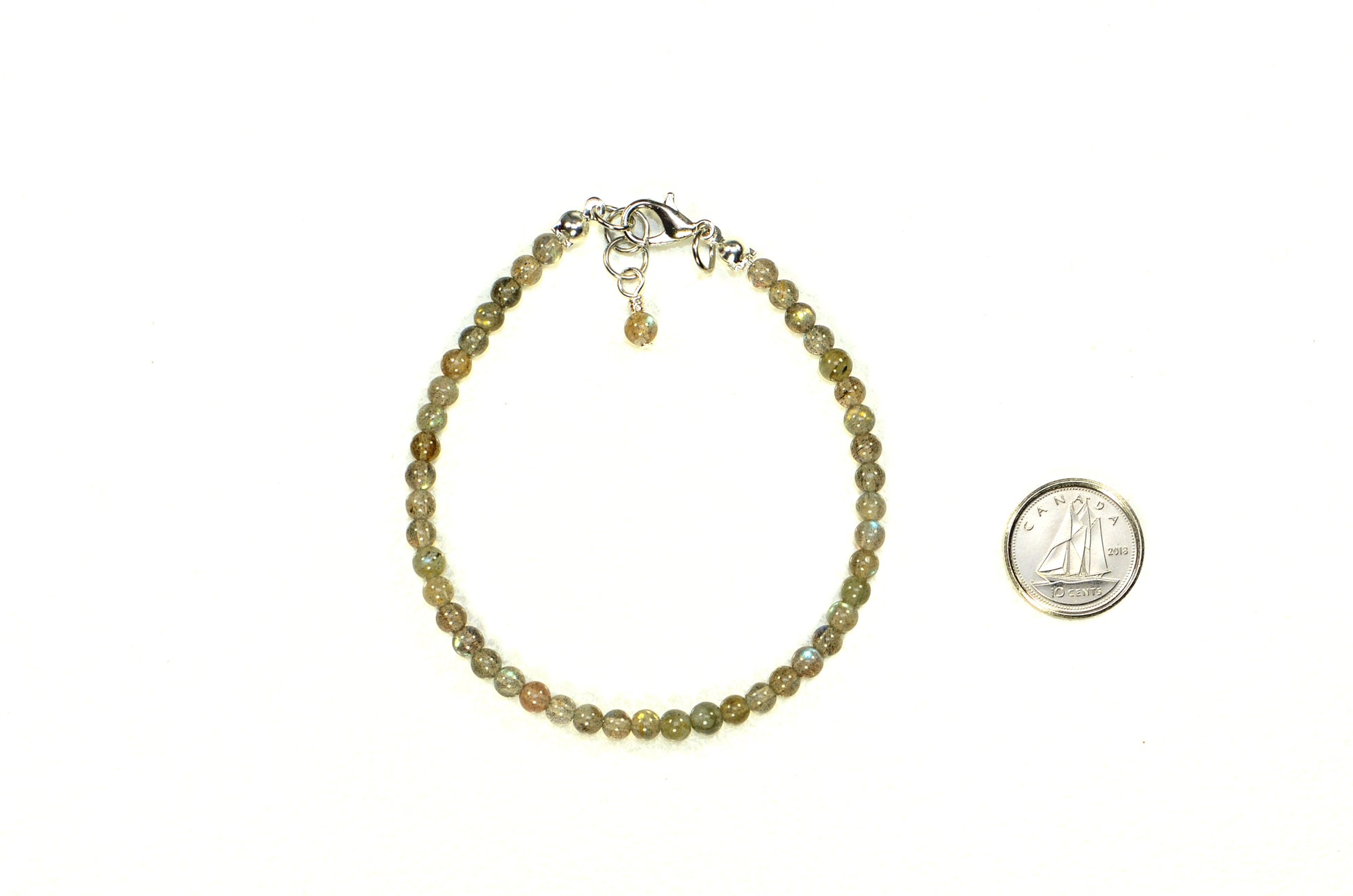 4mm Natural Labradorite Bracelet with Clasp beside a dime.