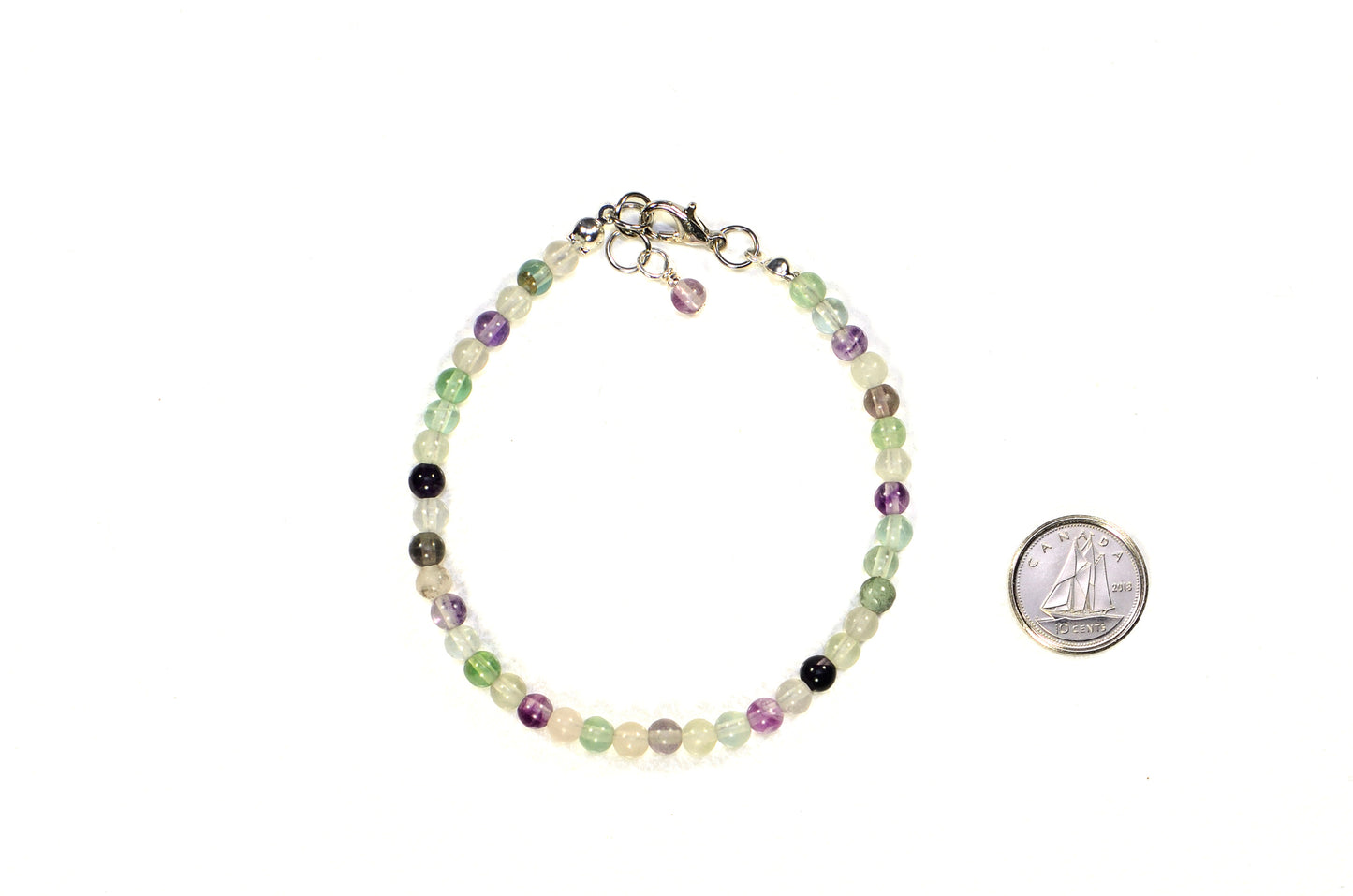 4mm Natural Rainbow Fluorite Bracelet with Clasp beside a dime.