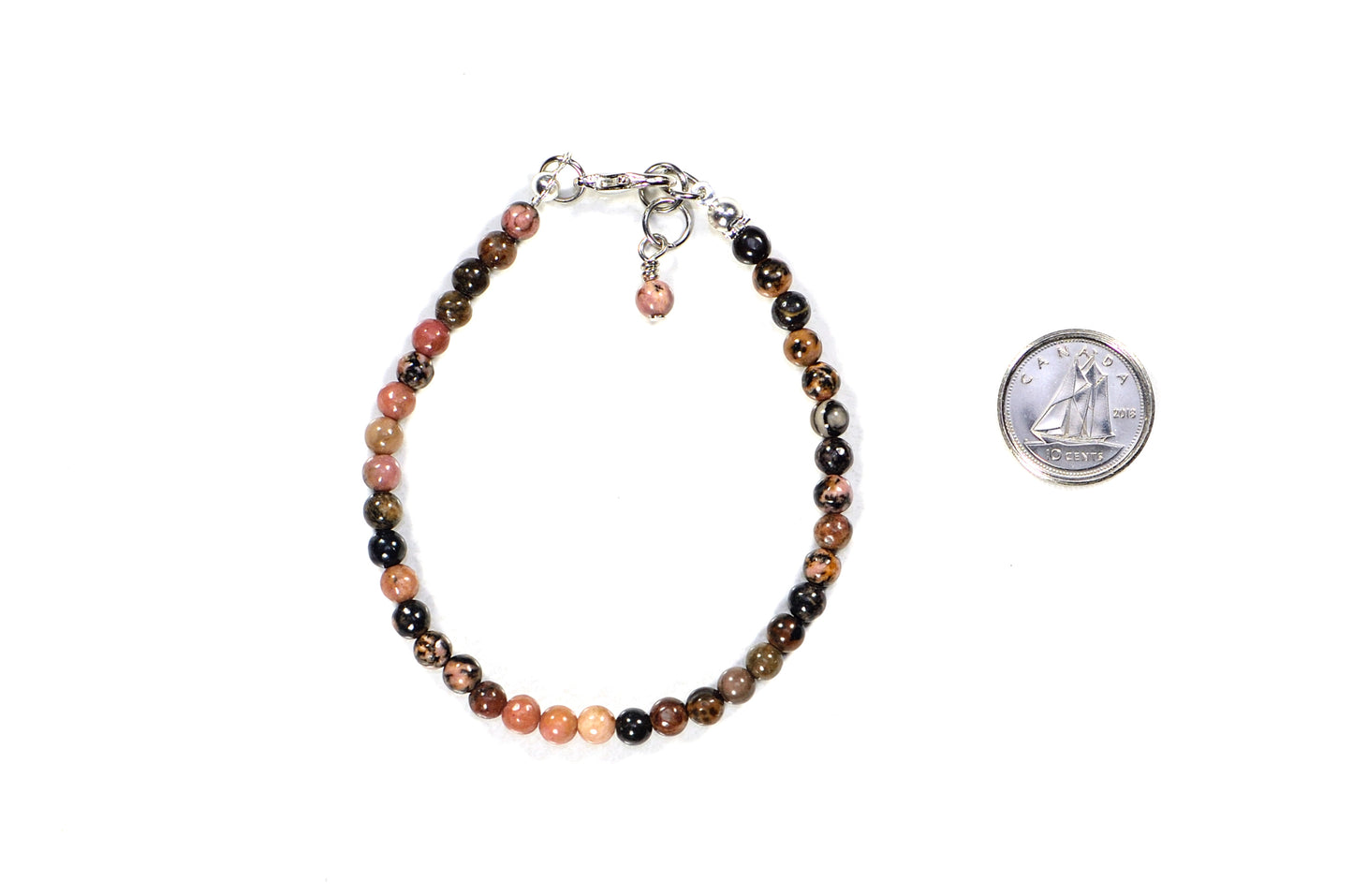 4mm Natural Rhodonite Bracelet with Clasp beside a dime.