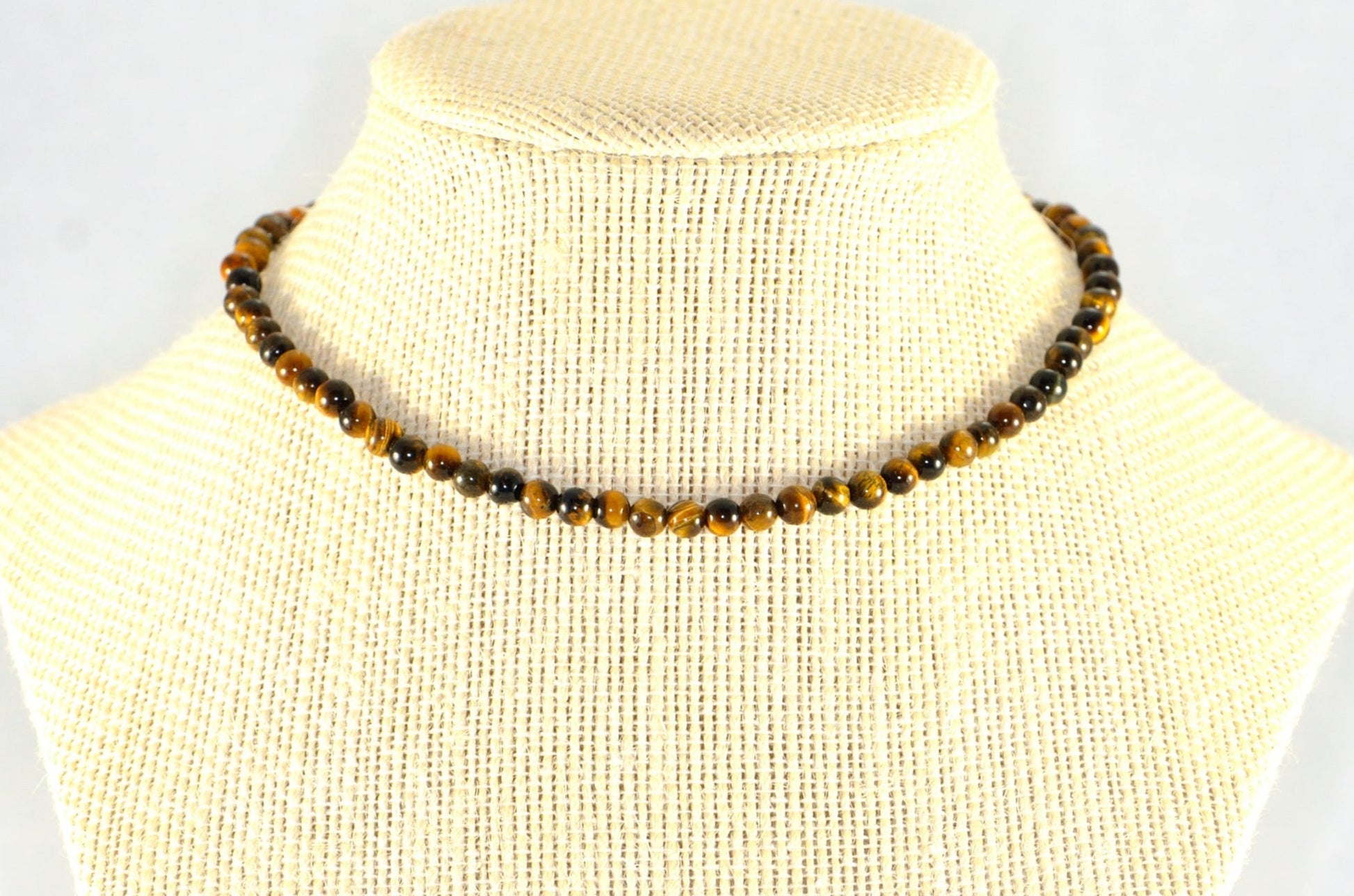 4mm Natural Tiger's Eye Choker Necklace displayed on a bust.