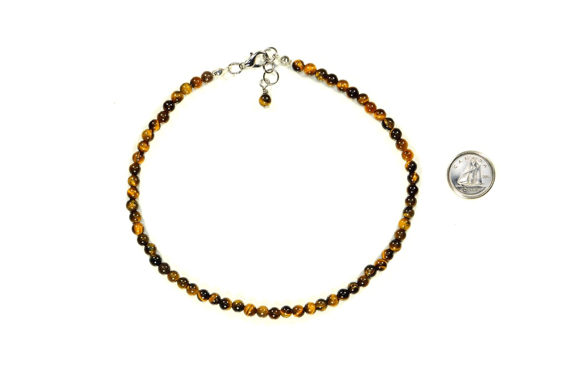 4mm Natural Tiger's Eye Choker Necklace beside a dime.