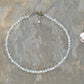 4mm Opal Crystal Choker Necklace beside a dime.