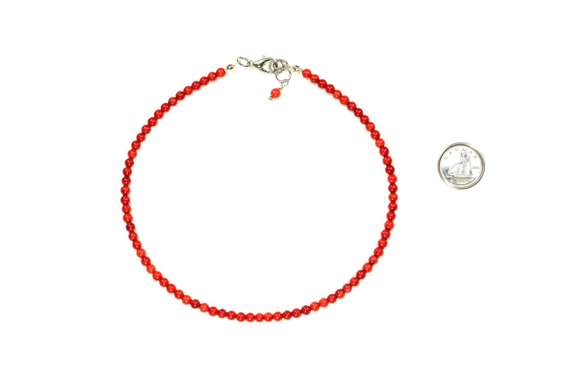 4mm Red Dyed Natural Coral Choker Necklace beside a dime.
