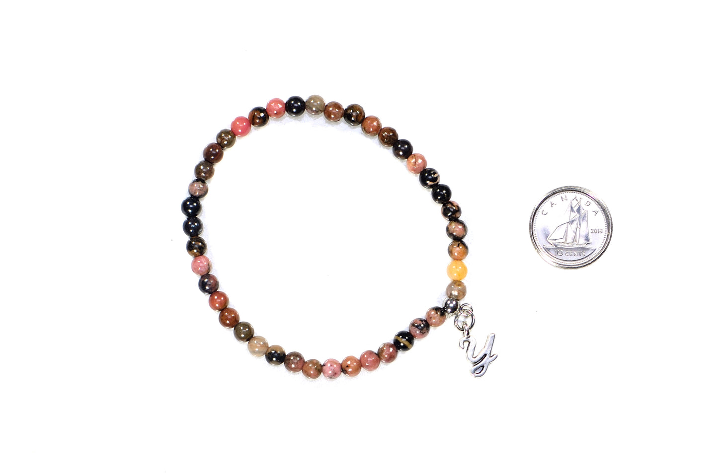 4mm Rhodonite Bracelet with Initial beside a dime.