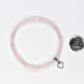4mm Rose Quartz Bracelet with Heart Charm beside a dime.